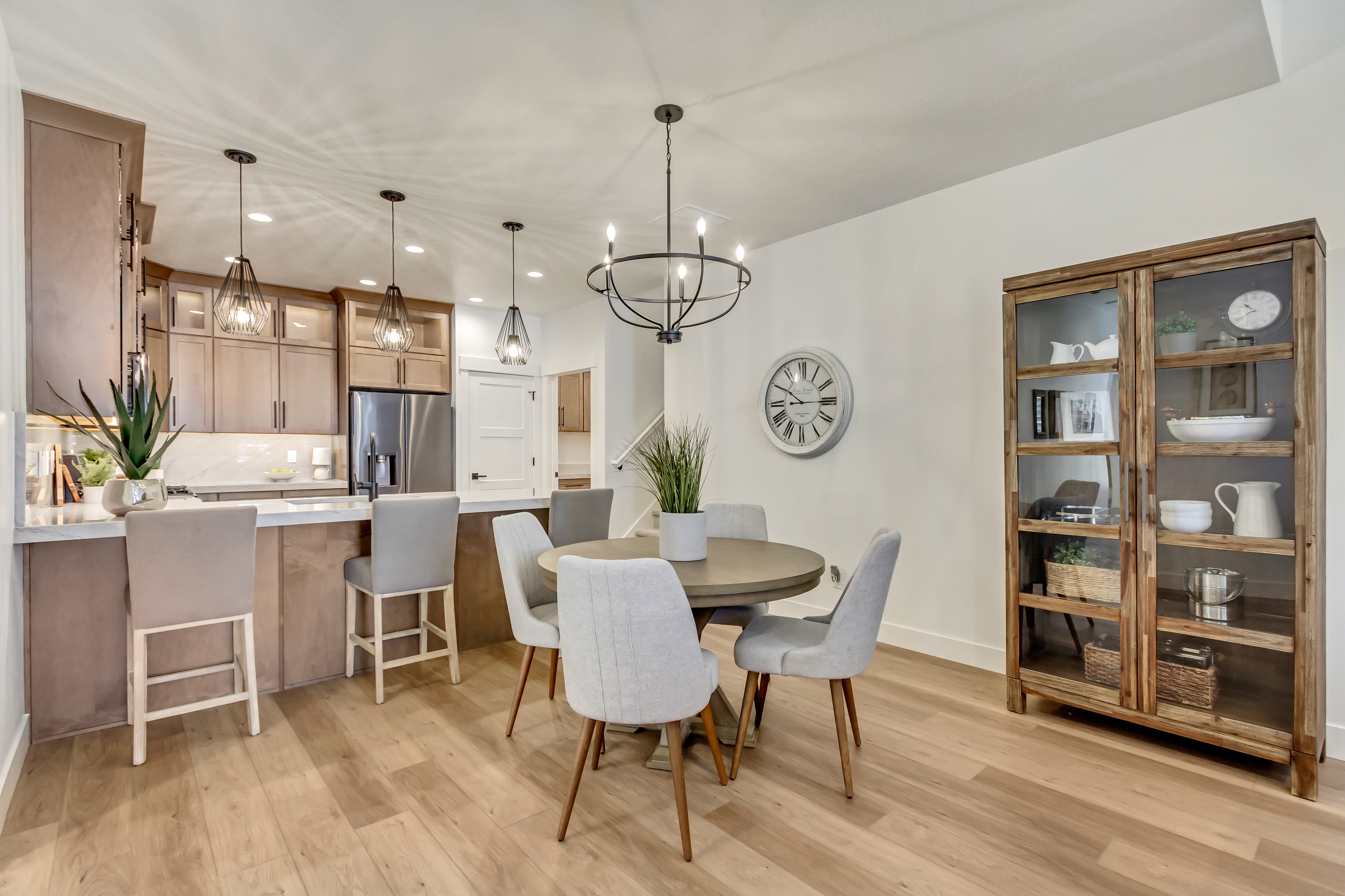 Kitchen with light wood-finish cabinetry, stainless steel appliances, and a peninsula with countertop seating