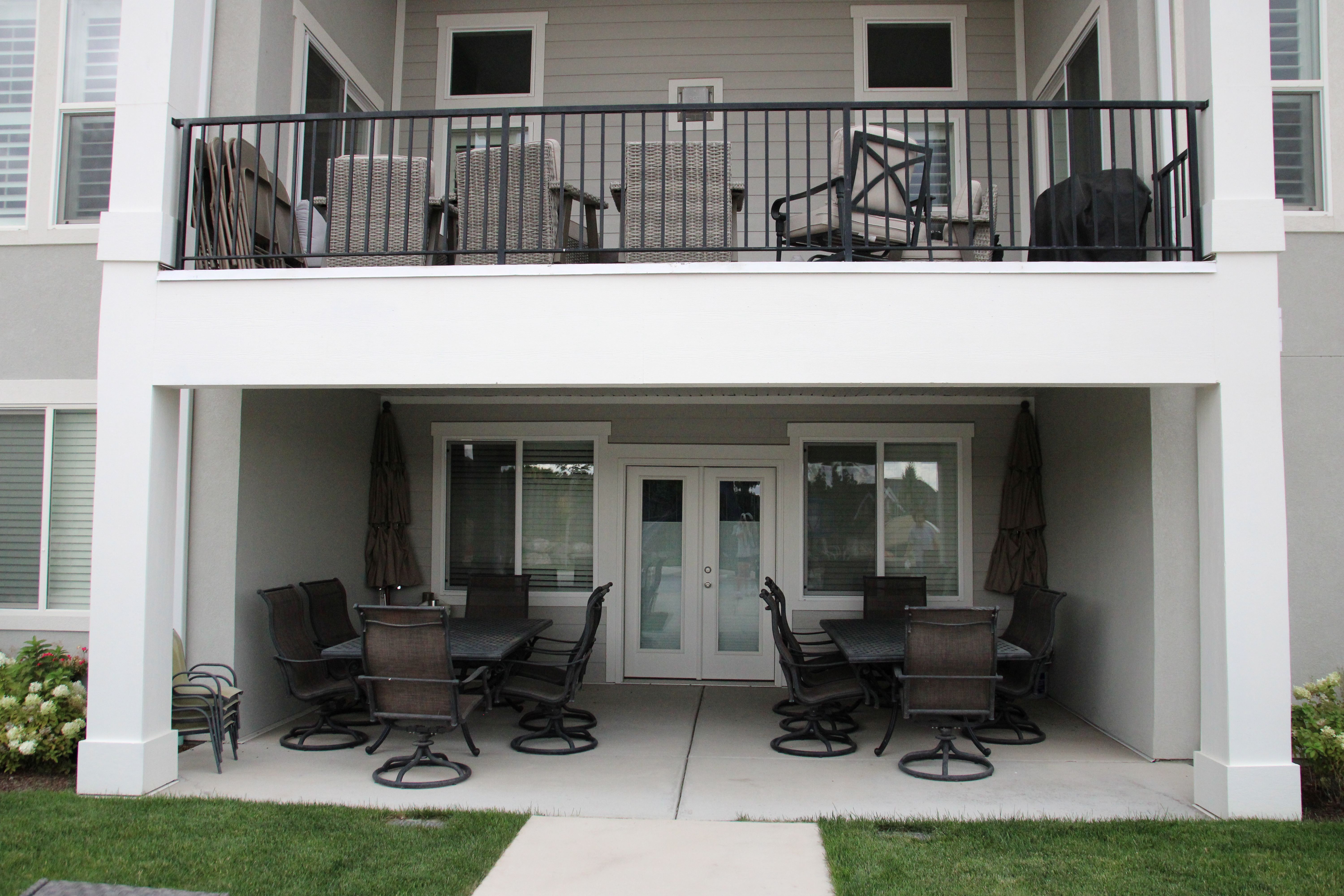 Covered patio featuring a concrete surface, direct lawn access, and double glass doors