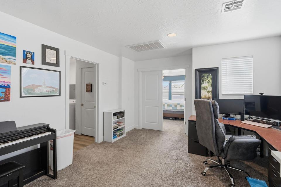 Carpeted room featuring white walls and a white ceiling with recessed lighting