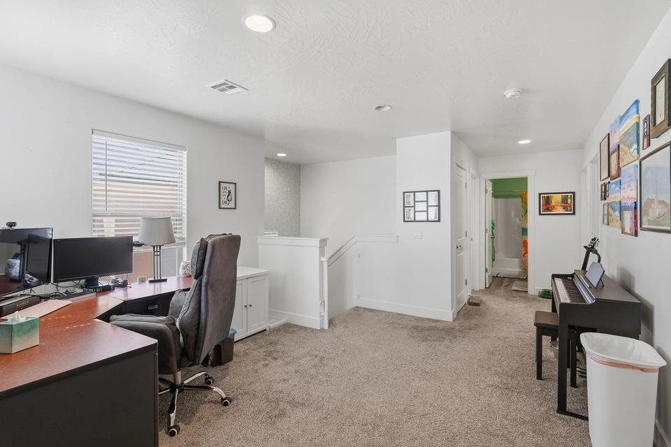 Open concept room featuring a window with blinds, light gray carpet, white walls, and recessed lighting