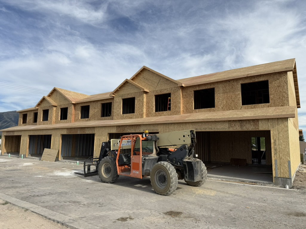 New construction townhome development featuring multiple units with individual garage entries