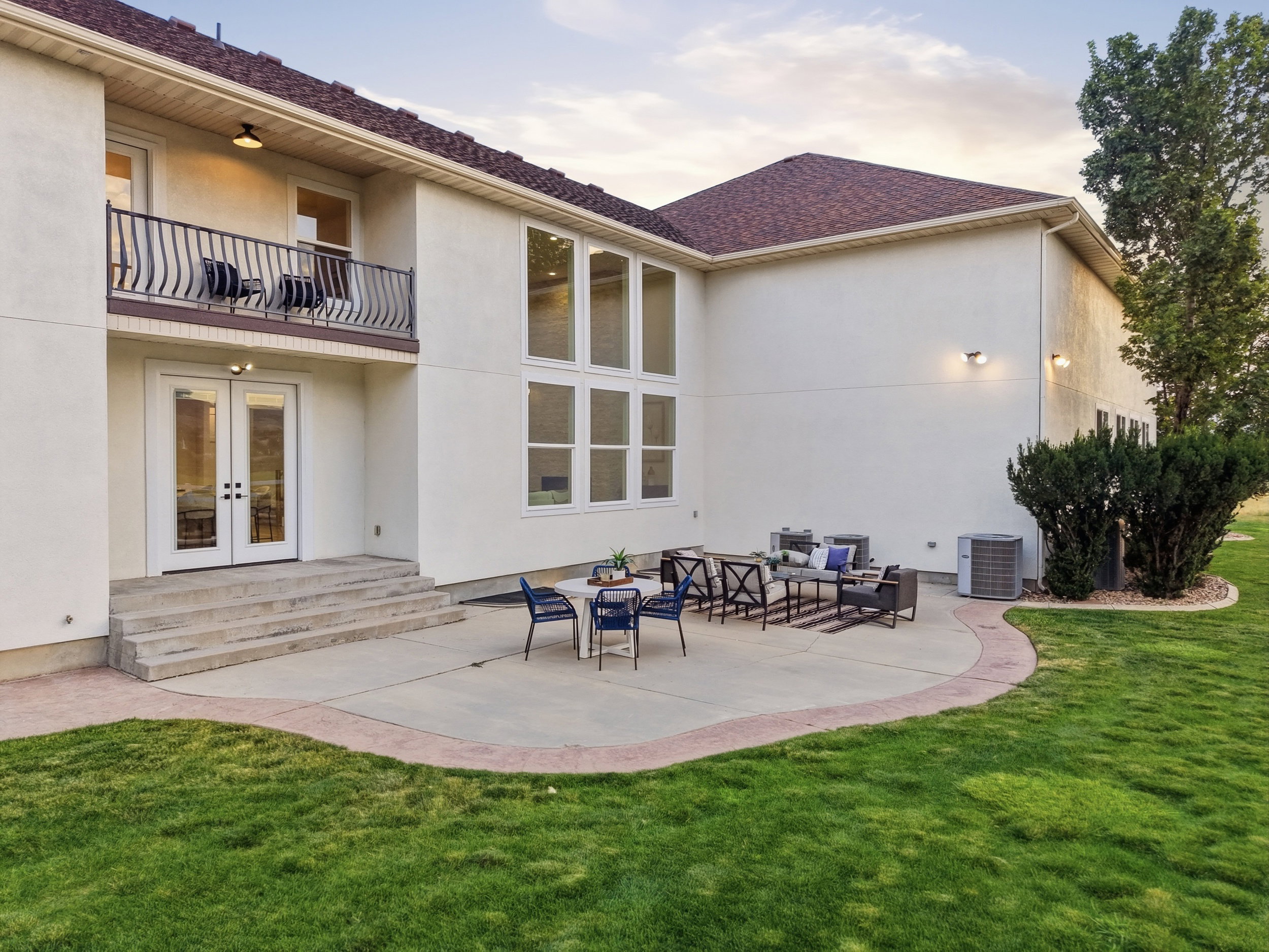 Spacious concrete patio with a decorative border and ample outdoor living space