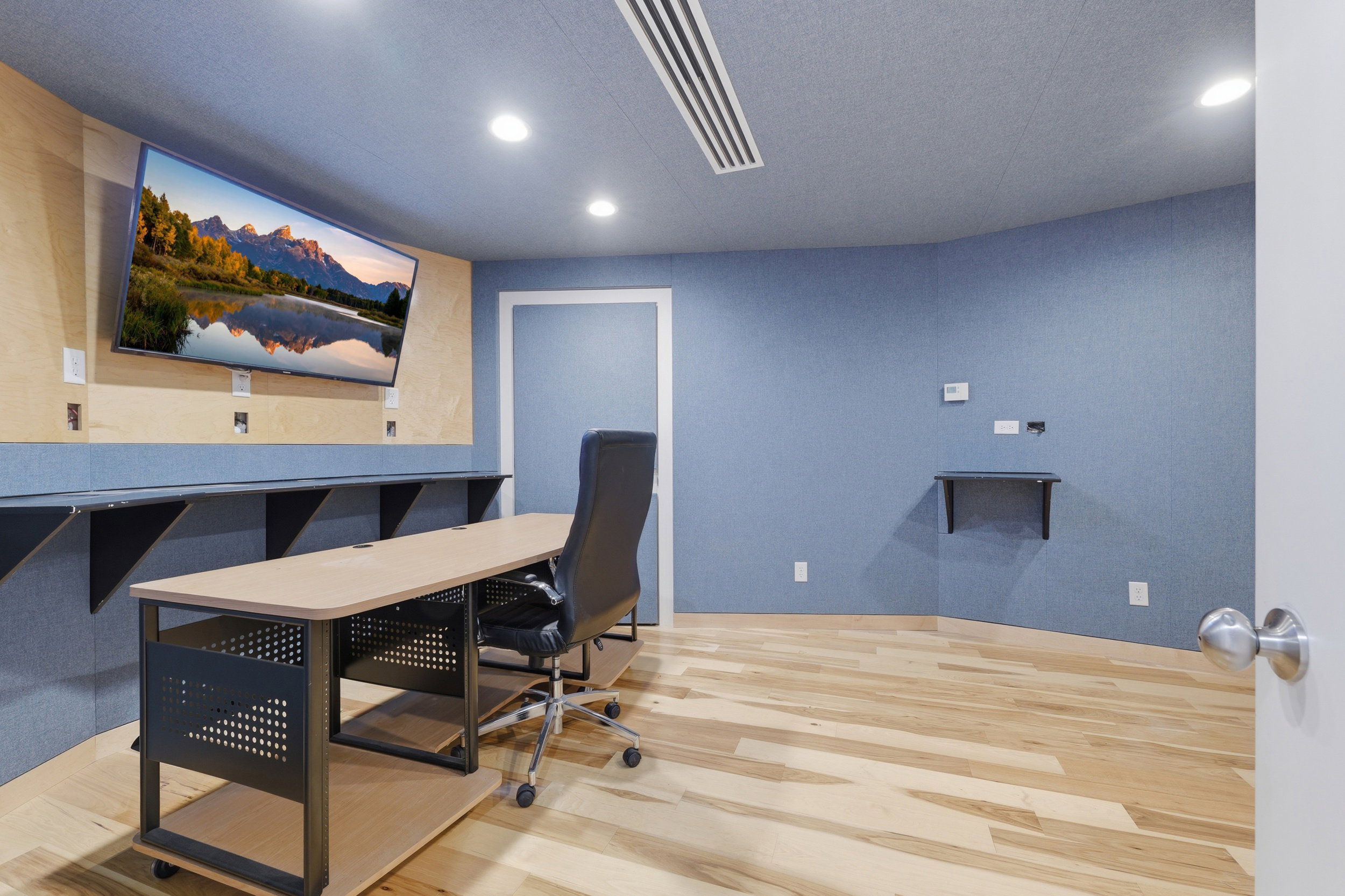 Room featuring light wood-finish flooring, recessed lighting, and a wall-mounted television