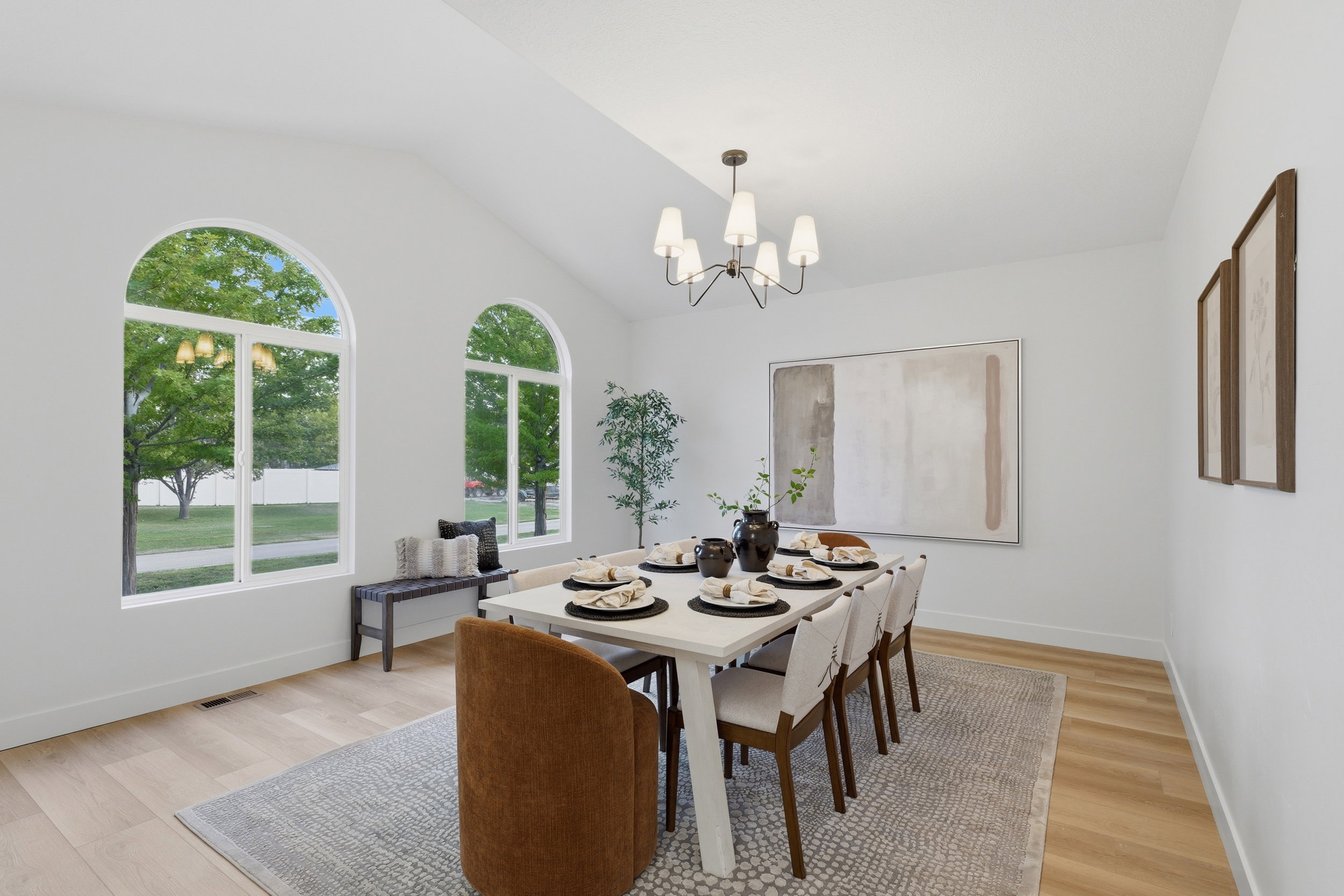 Vaulted ceilings highlight a dedicated dining area featuring wood-finish flooring