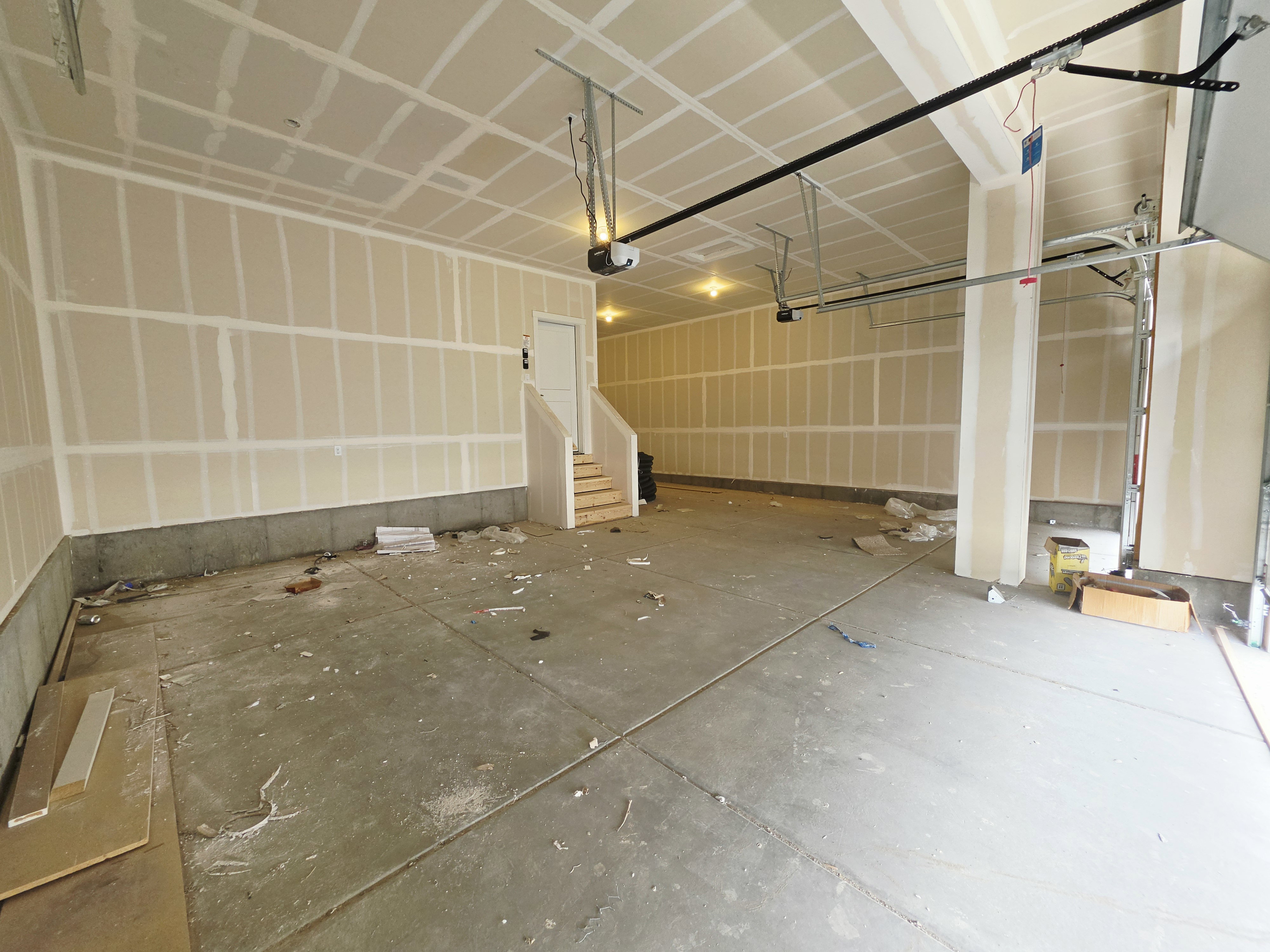 Spacious garage featuring concrete flooring and unfinished drywall, ready for customization