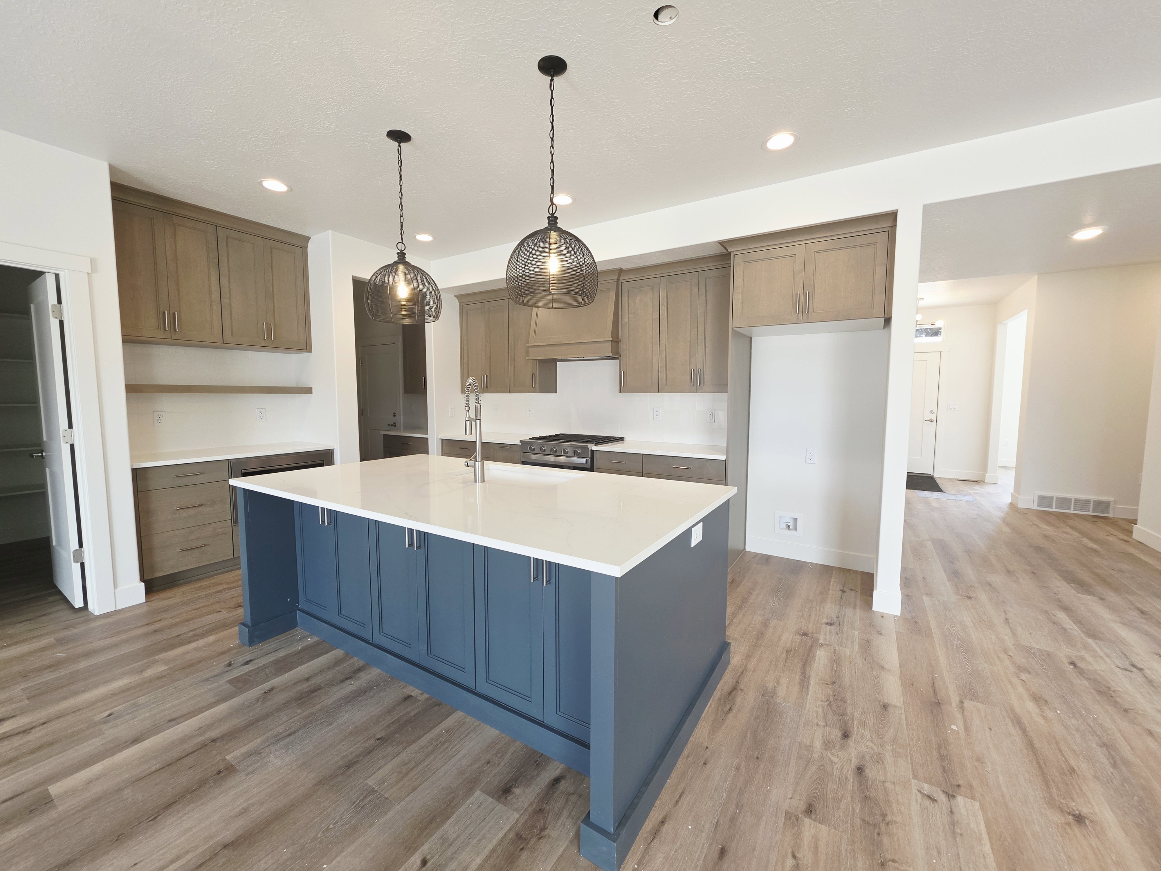 Kitchen featuring a large island with a white countertop and blue cabinetry