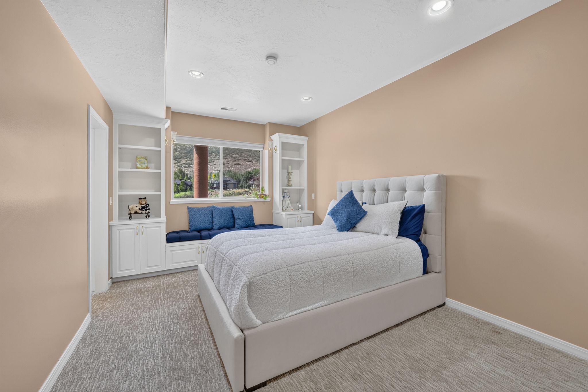 Bedroom featuring neutral-toned walls and light-toned carpet flooring