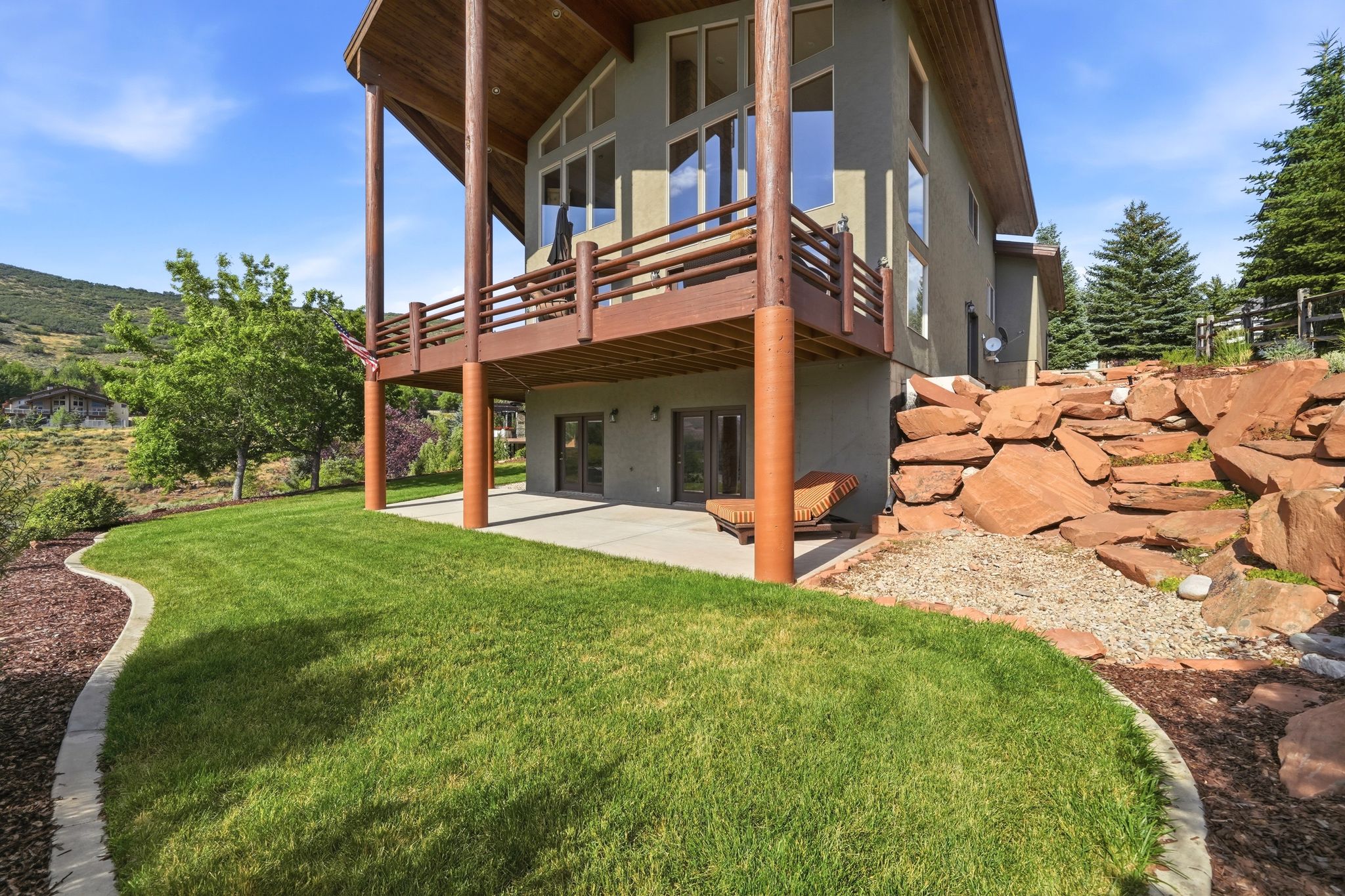 Multi-level structure with a stucco exterior and exposed wood beams
