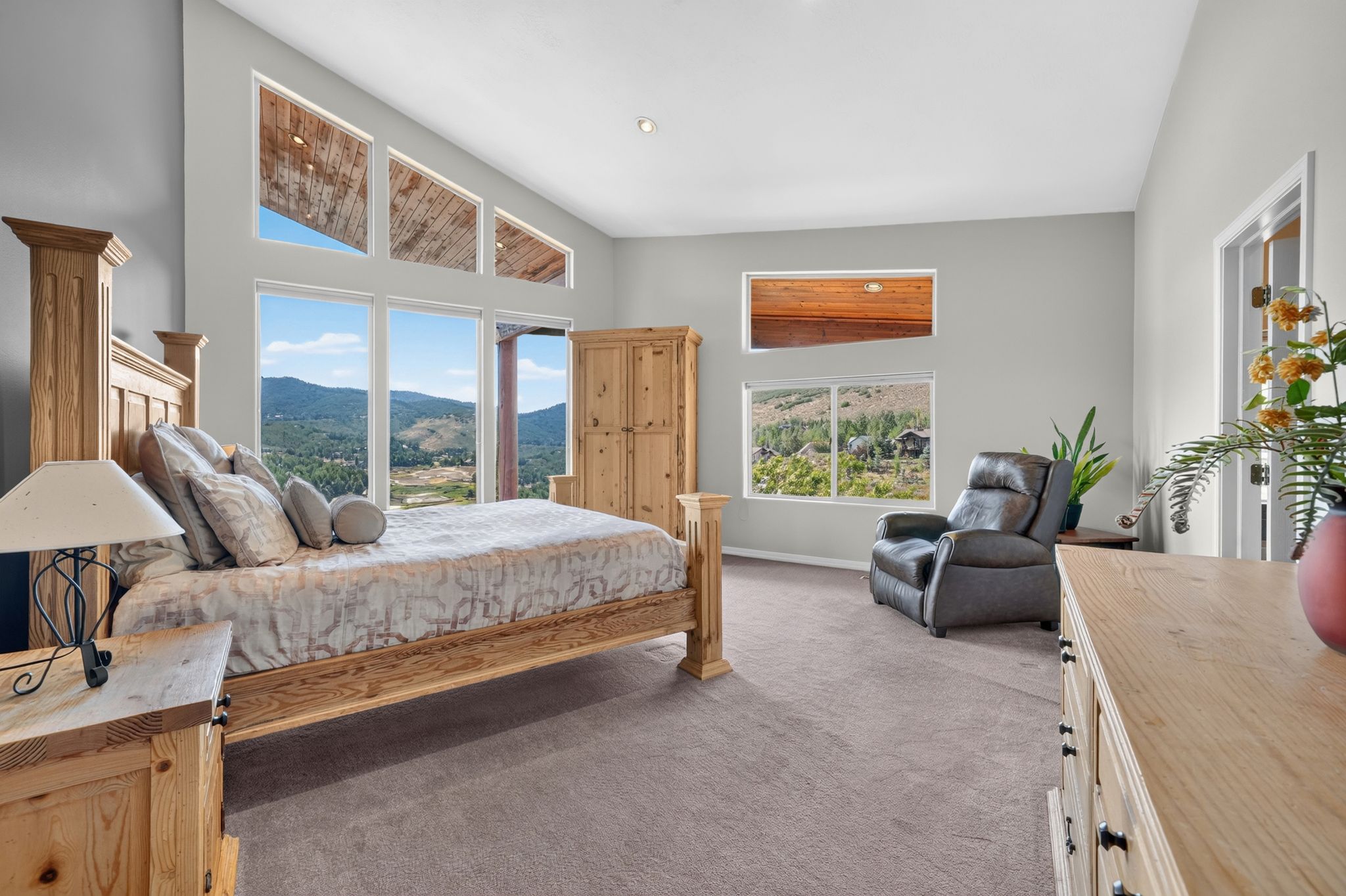 Vaulted ceilings with clerestory windows, expansive floor-to-ceiling windows, and recessed lighting