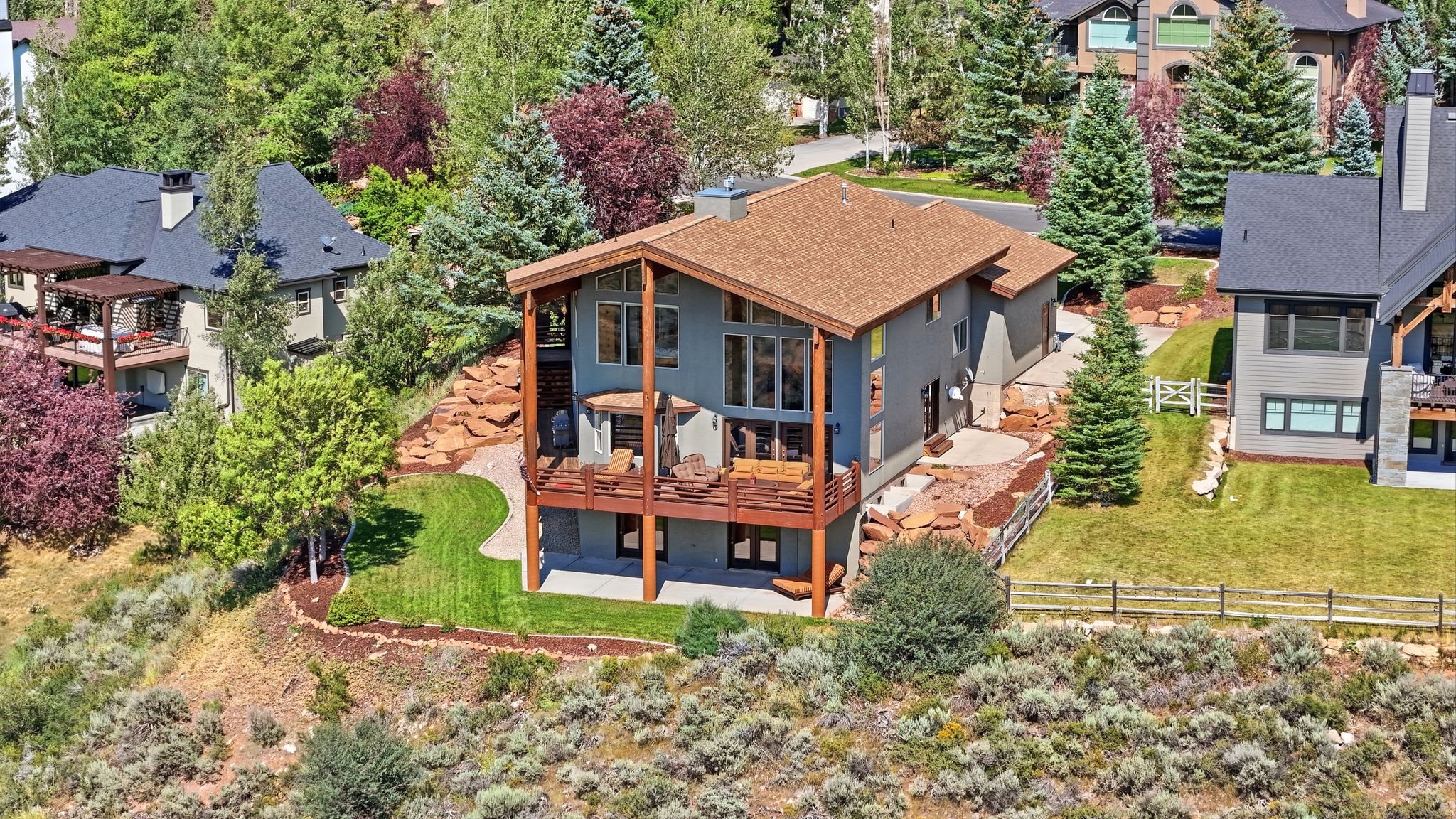Contemporary multi-level residence featuring expansive decking and a natural wood-finish roof