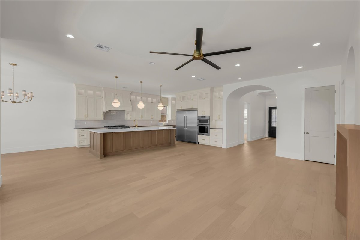 Open-concept living space featuring wood-finish flooring throughout