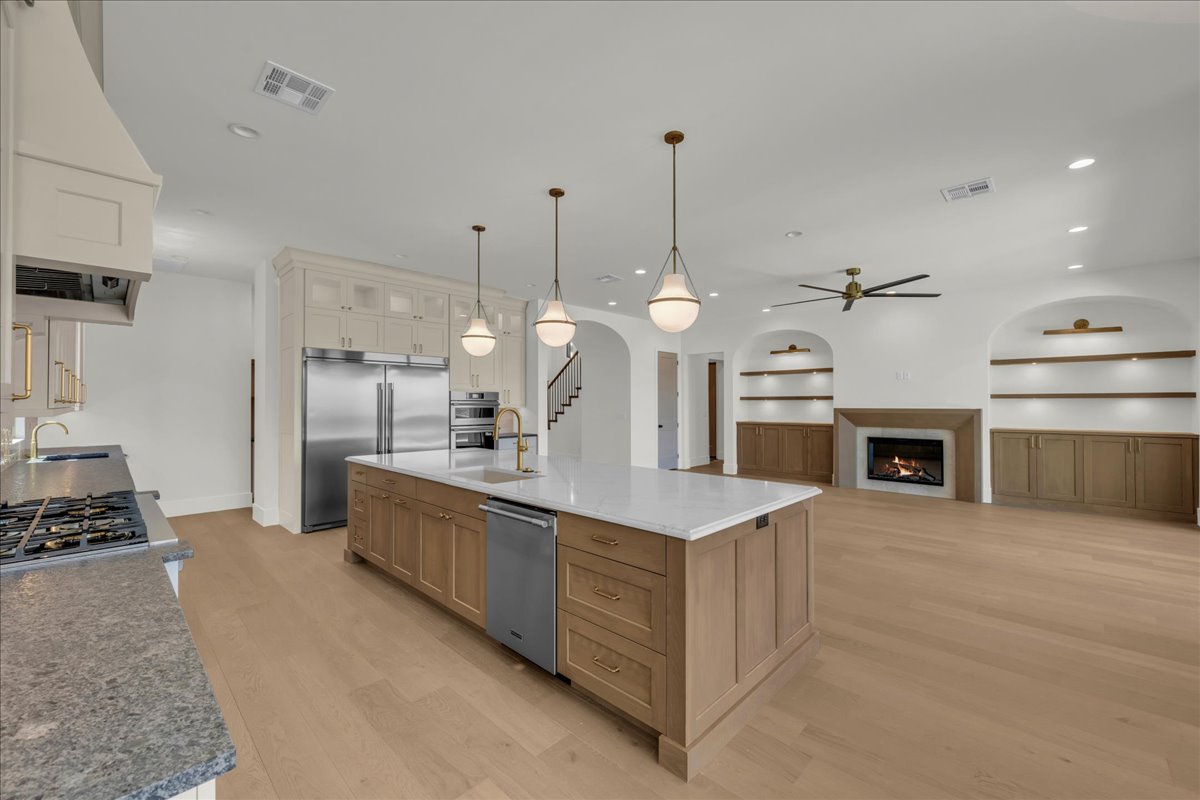 Open-concept living space with light wood-finish flooring
