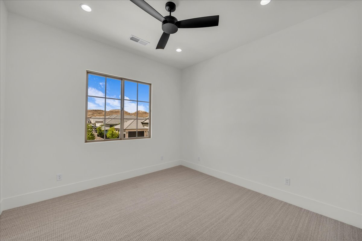 Room with neutral wall tones and patterned carpeting