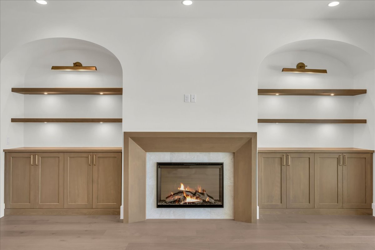 Built-in fireplace with a light-toned mantel and stone surround