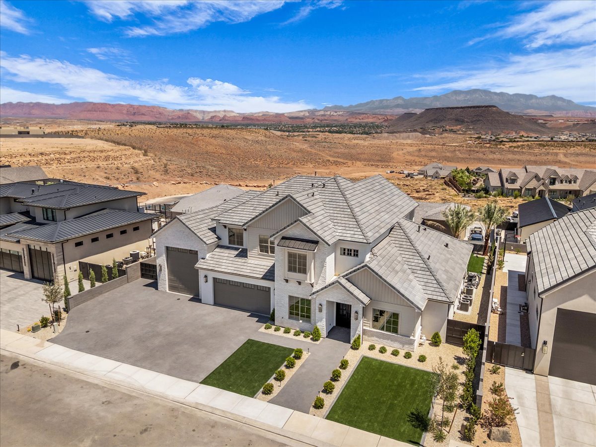 Contemporary white stucco exterior with multiple gables and a gray tile roof