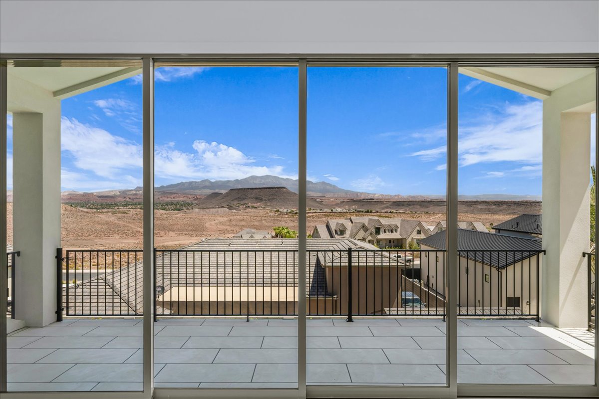 Expansive outdoor balcony featuring large format tile flooring and black metal railings