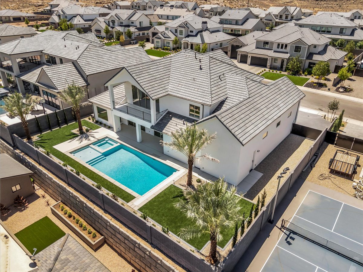 Contemporary white exterior featuring a gabled roofline and multiple windows