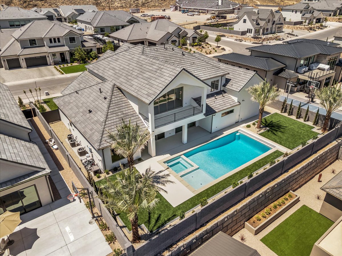 Modern residence featuring a crisp white exterior and dark tile roofing