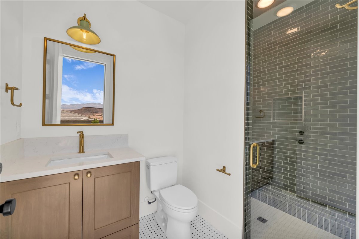 Modern bathroom featuring a wood-finish vanity with a white countertop and rectangular undermount sink