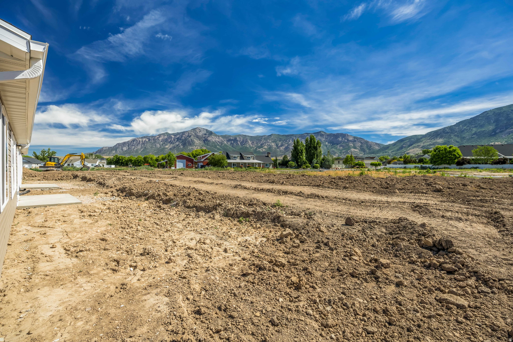 Expansive cleared lot with mountain backdrop