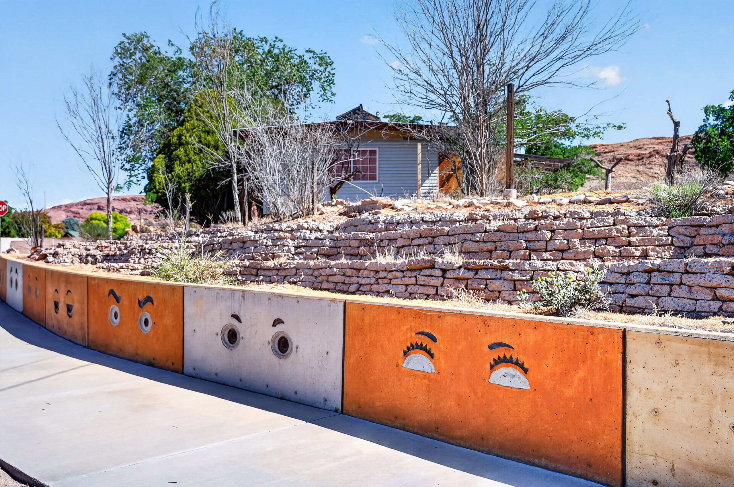 Decorative concrete retaining wall featuring artistic cutouts