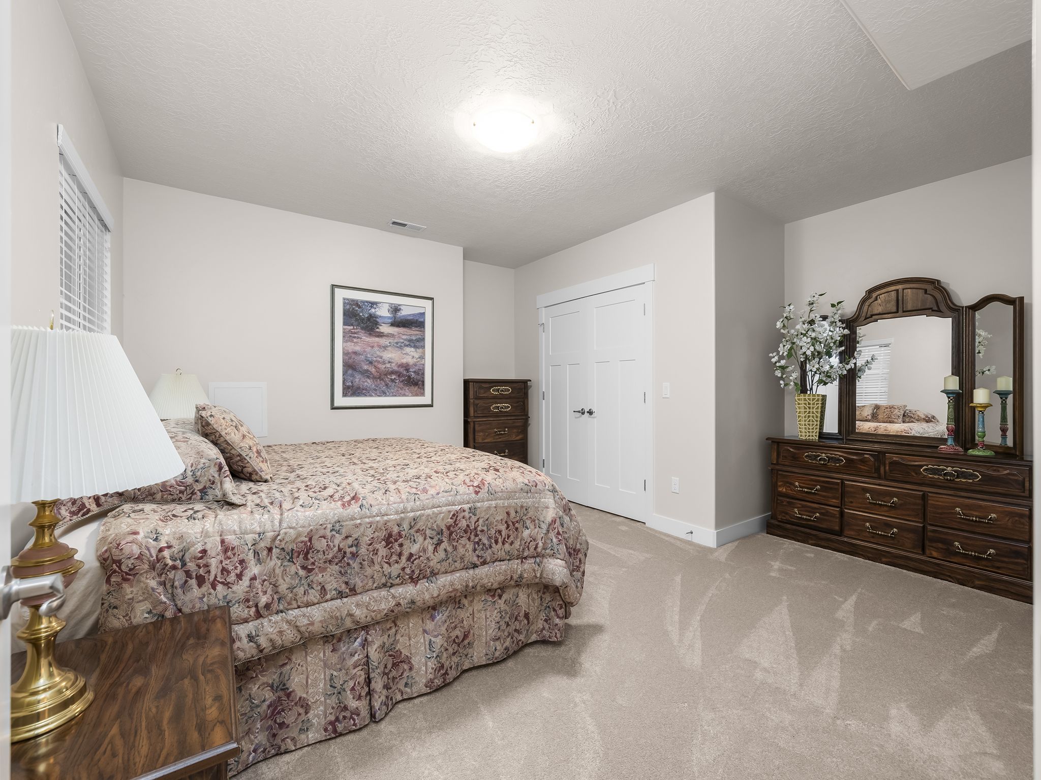 Neutral-toned walls complement the light-colored carpeting throughout