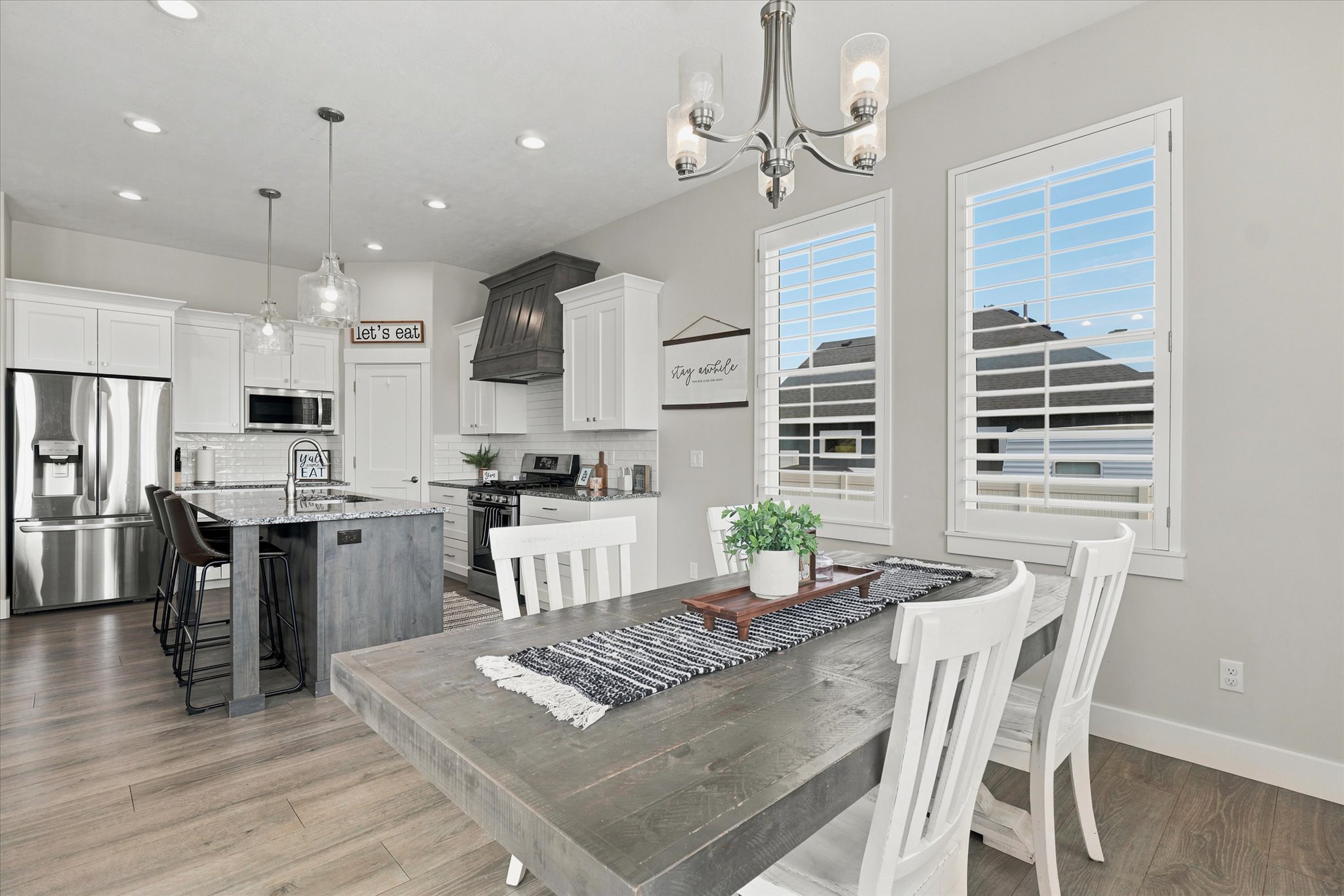 Open-concept kitchen and dining area featuring wood-finish flooring
