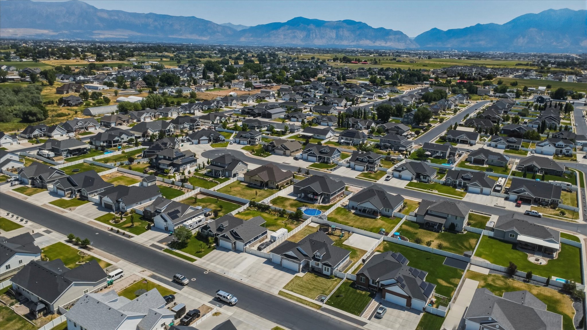 Aerial perspective showcasing a residential neighborhood with a mountain backdrop