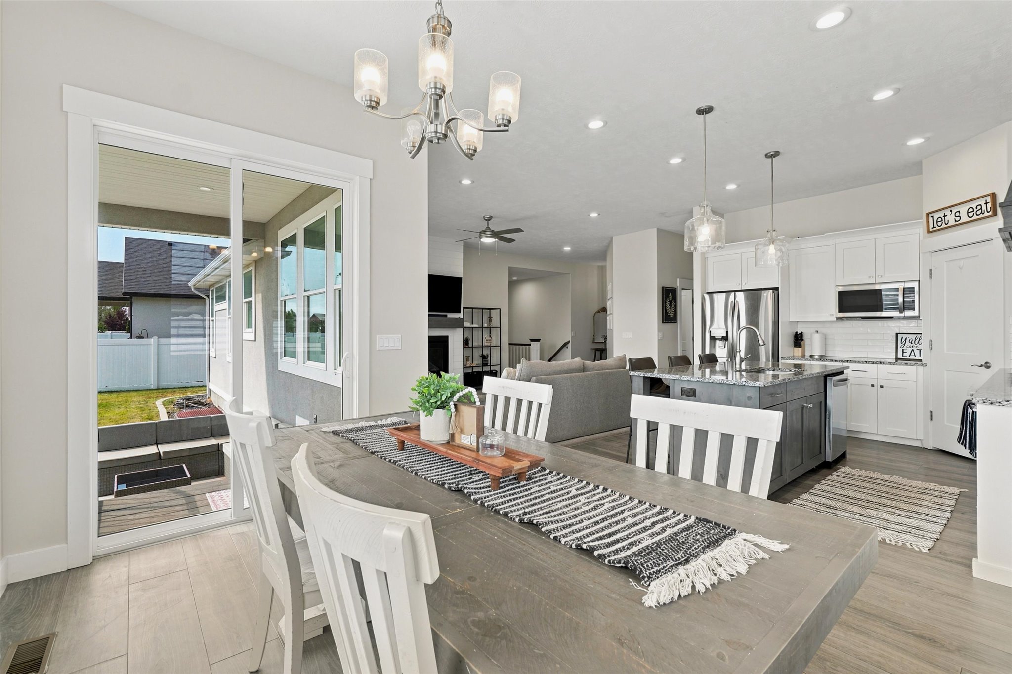 Dining area with wood-finish flooring and a contemporary chandelier
