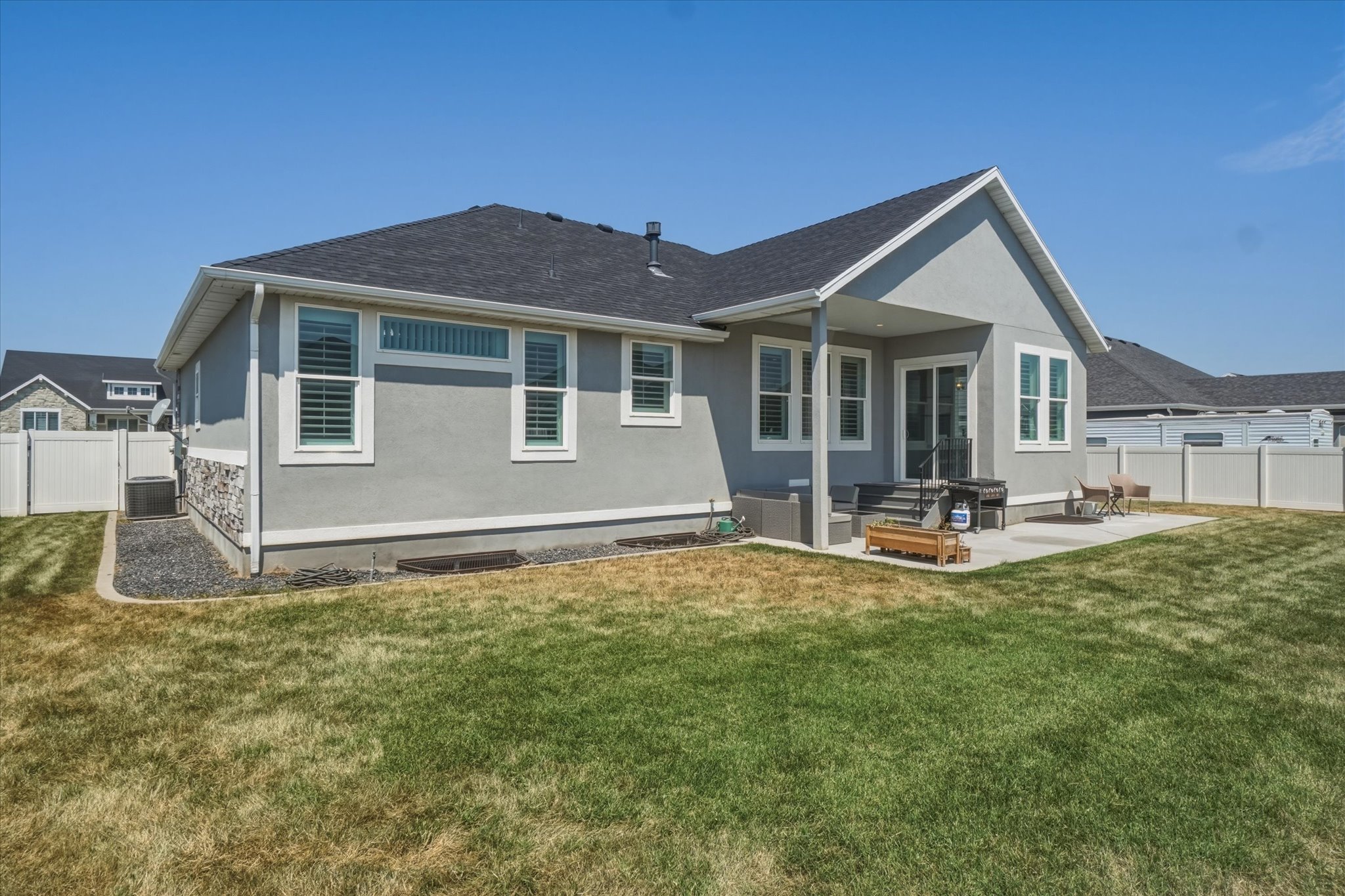 Rear exterior featuring a covered patio, concrete patio, and a privacy fence