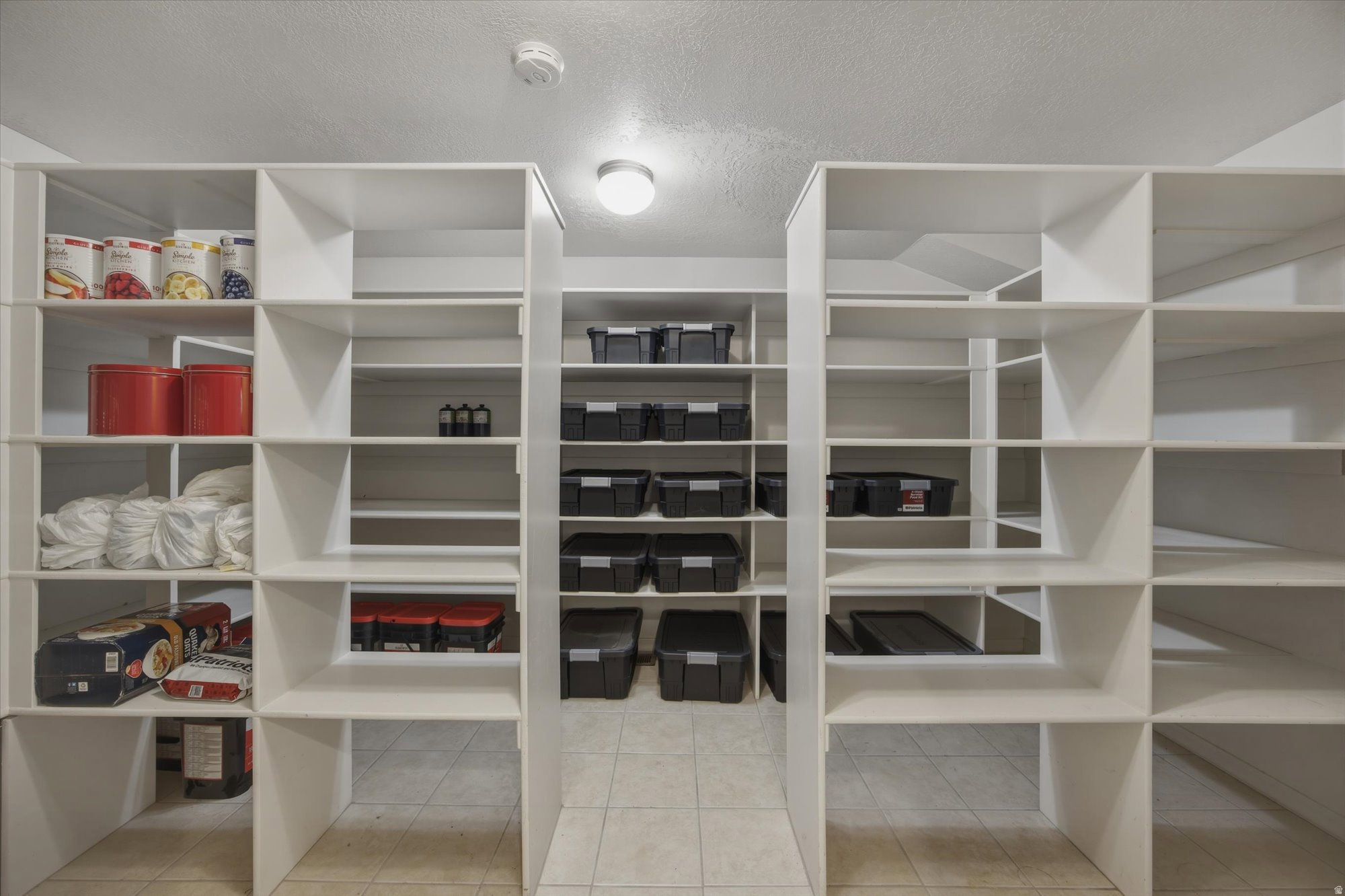 Built-in storage shelving system featuring multiple bays and adjustable white shelves