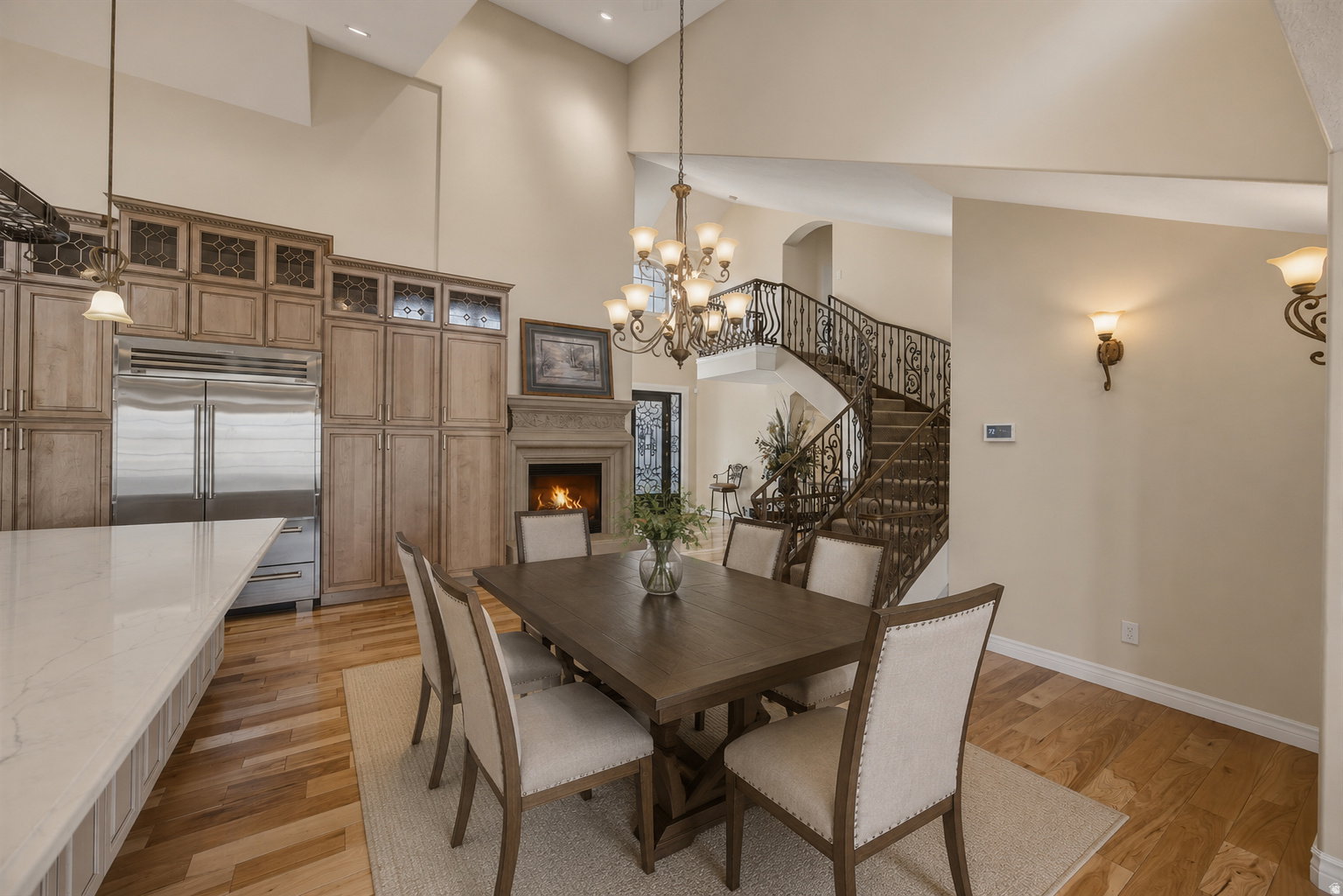 Open-concept dining area featuring a wood-finish dining table and light wood-finish flooring