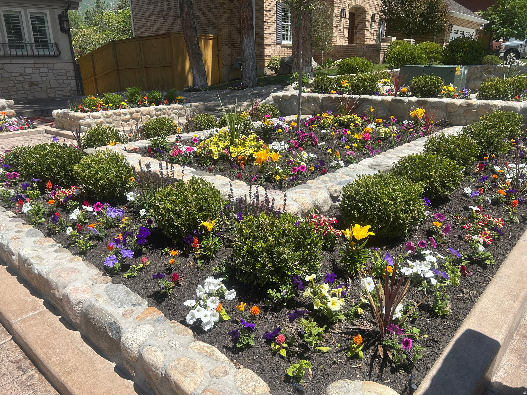 Tiered landscaping featuring natural stone retaining walls