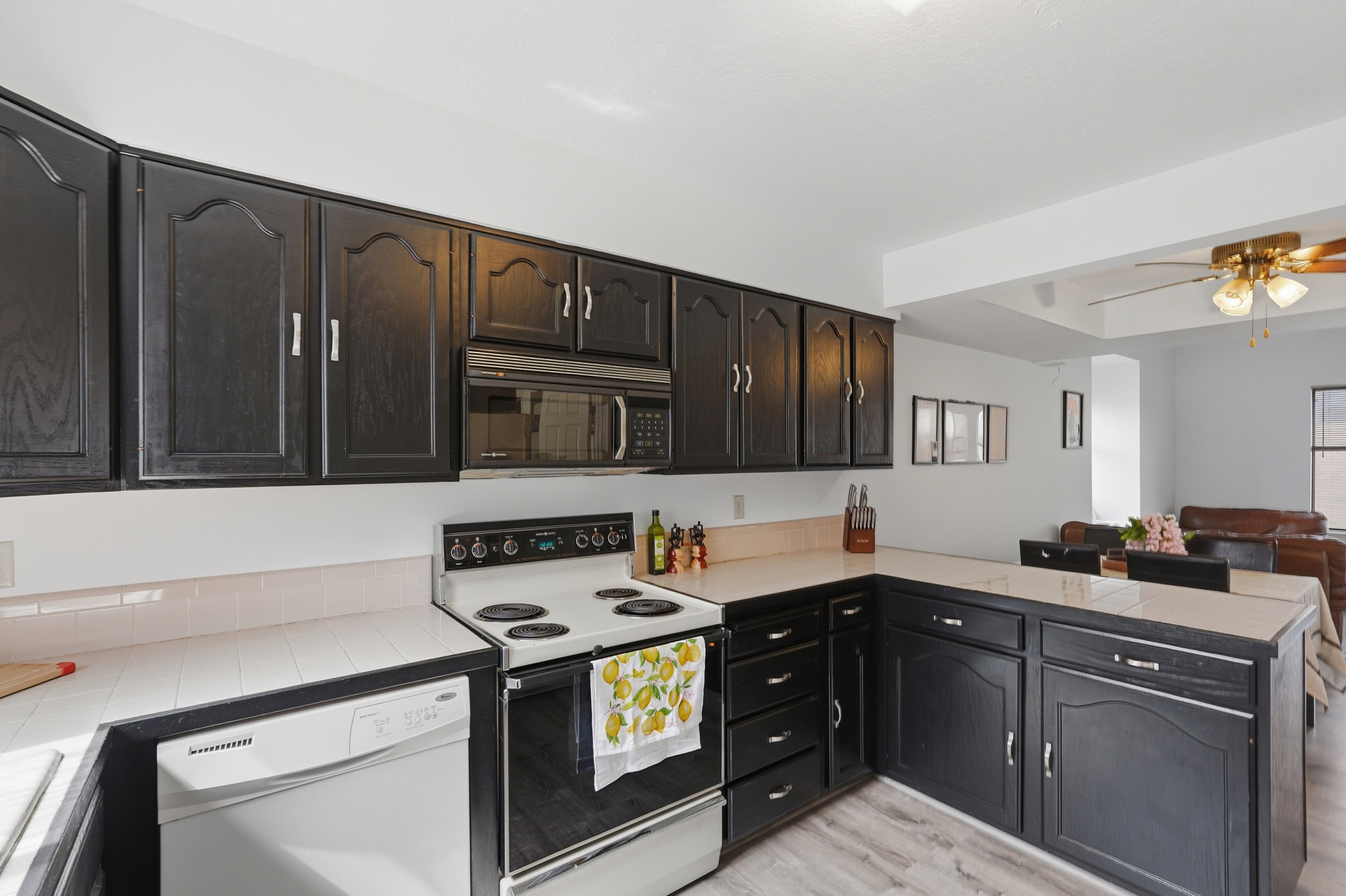 Open concept kitchen featuring dark wood-finish cabinetry