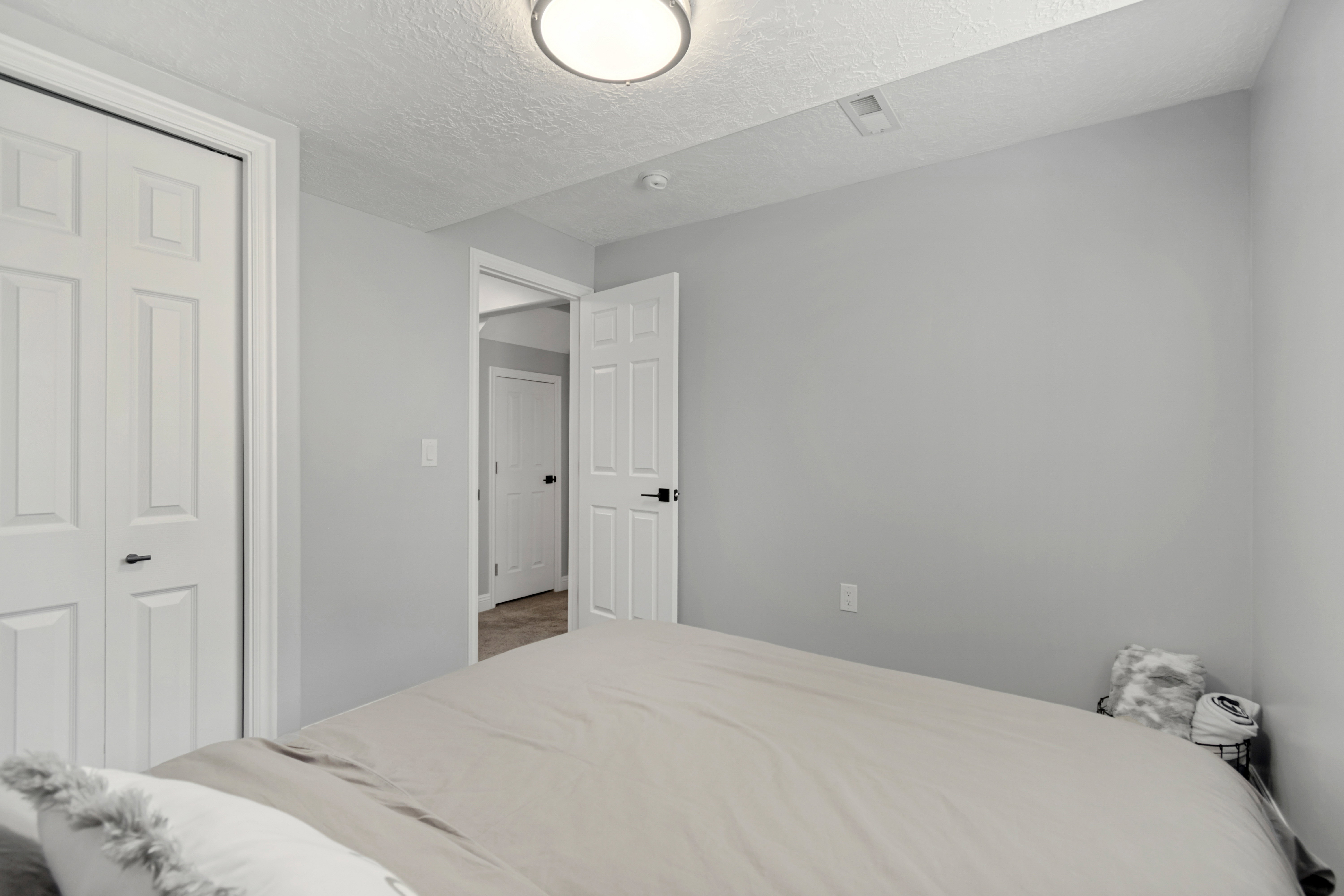 Bedroom featuring light gray walls, white trim, and a flush mount ceiling light