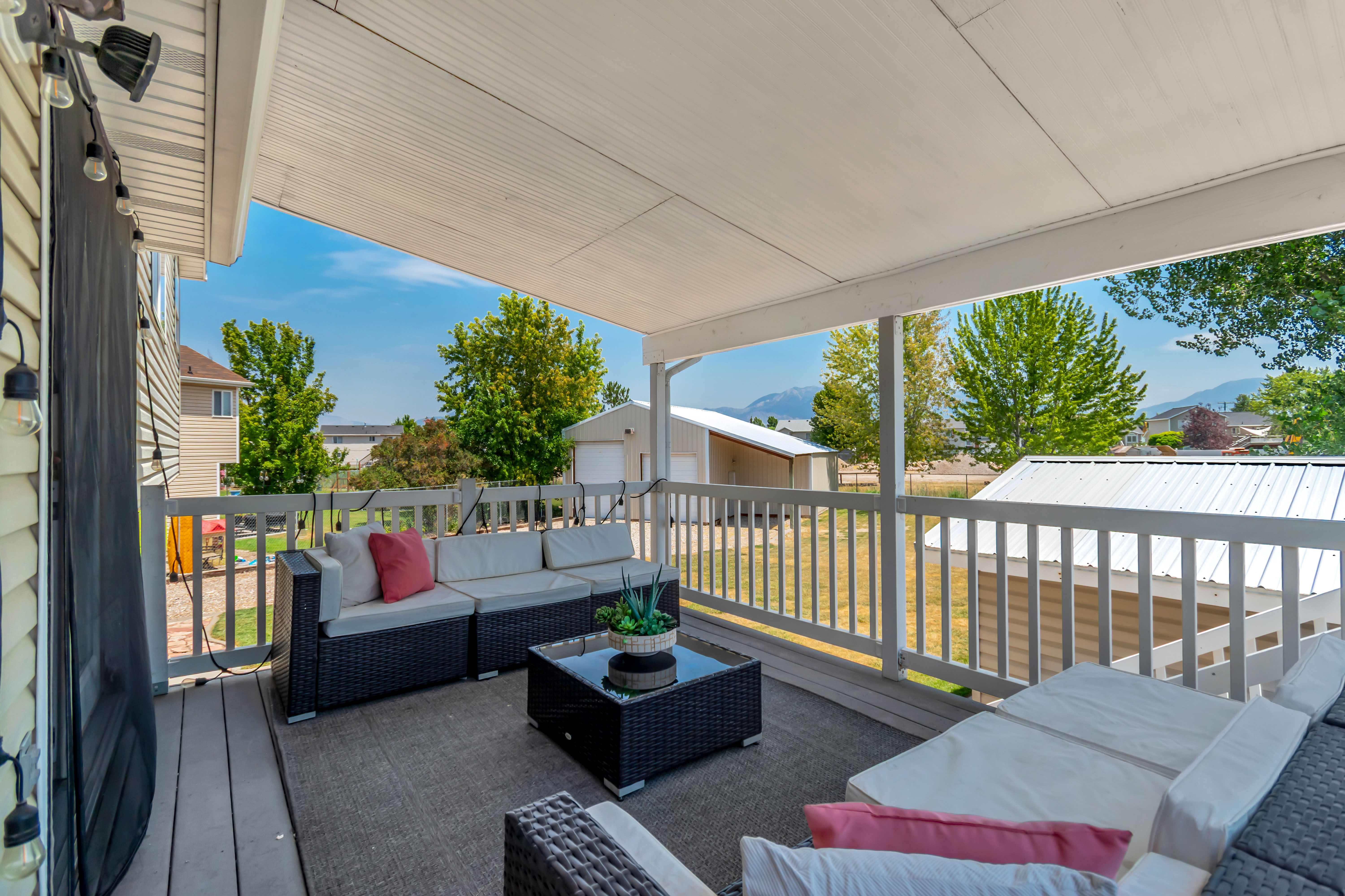 Covered outdoor deck with wood-finish flooring