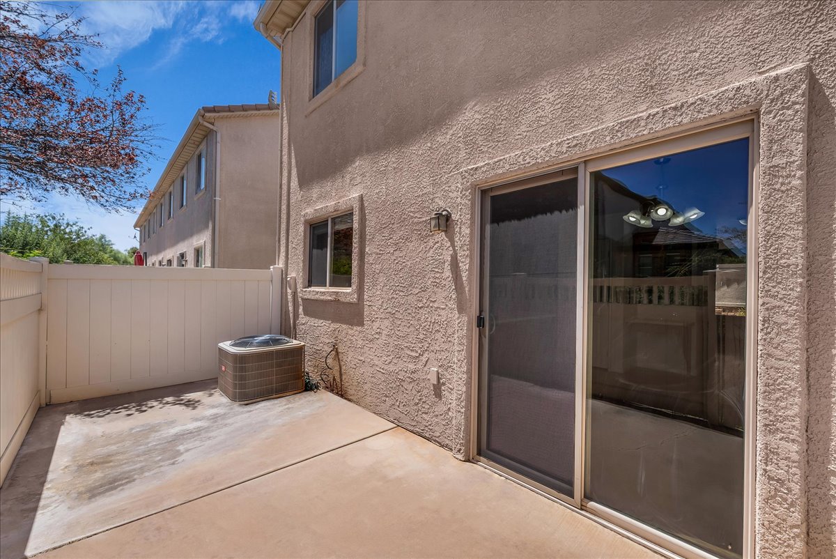 Enjoy a low-maintenance private patio with a concrete surface, sliding glass door access, and privacy fencing—perfect for relaxing or entertaining.