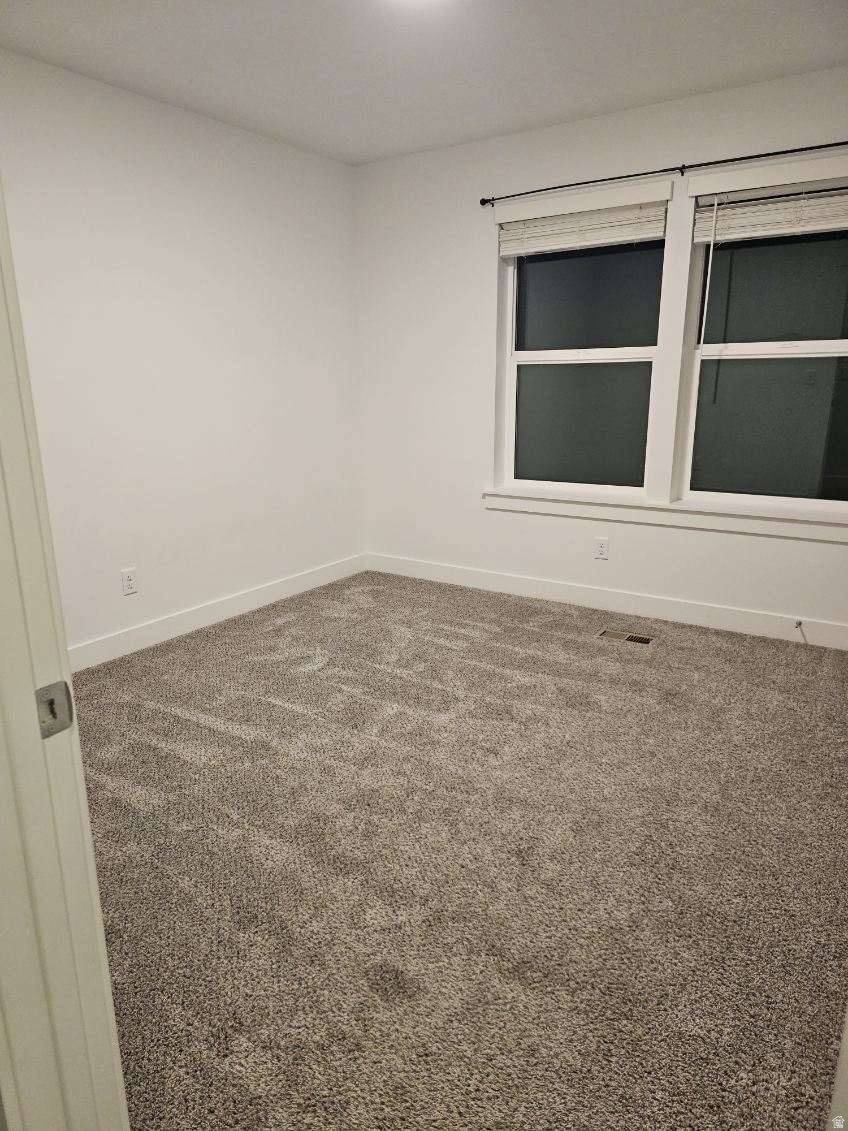 Room featuring light gray carpeting, white walls, and white trim