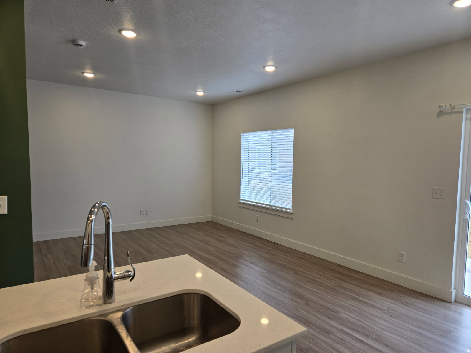 Kitchen island featuring a double basin stainless steel sink with a gooseneck faucet