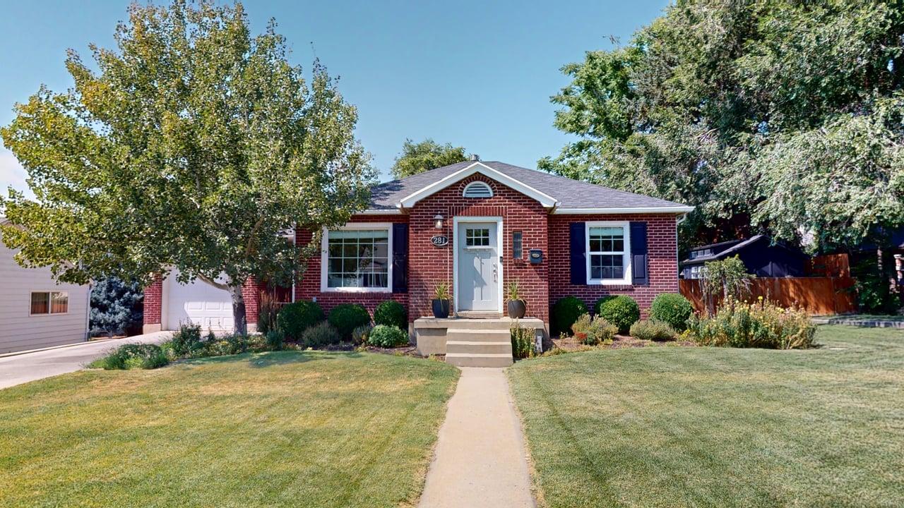 Red brick exterior with white trim windows and dark shutters