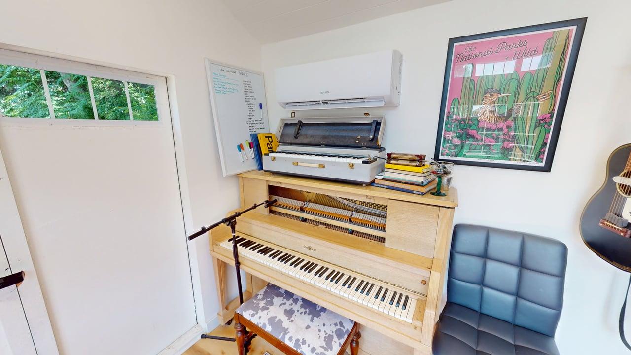 Light-toned wood piano with white and black keys