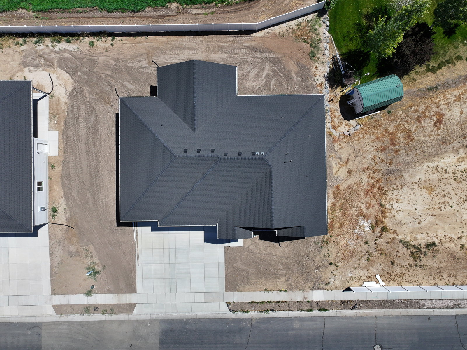 Dark asphalt shingle roofing with multiple roof vents