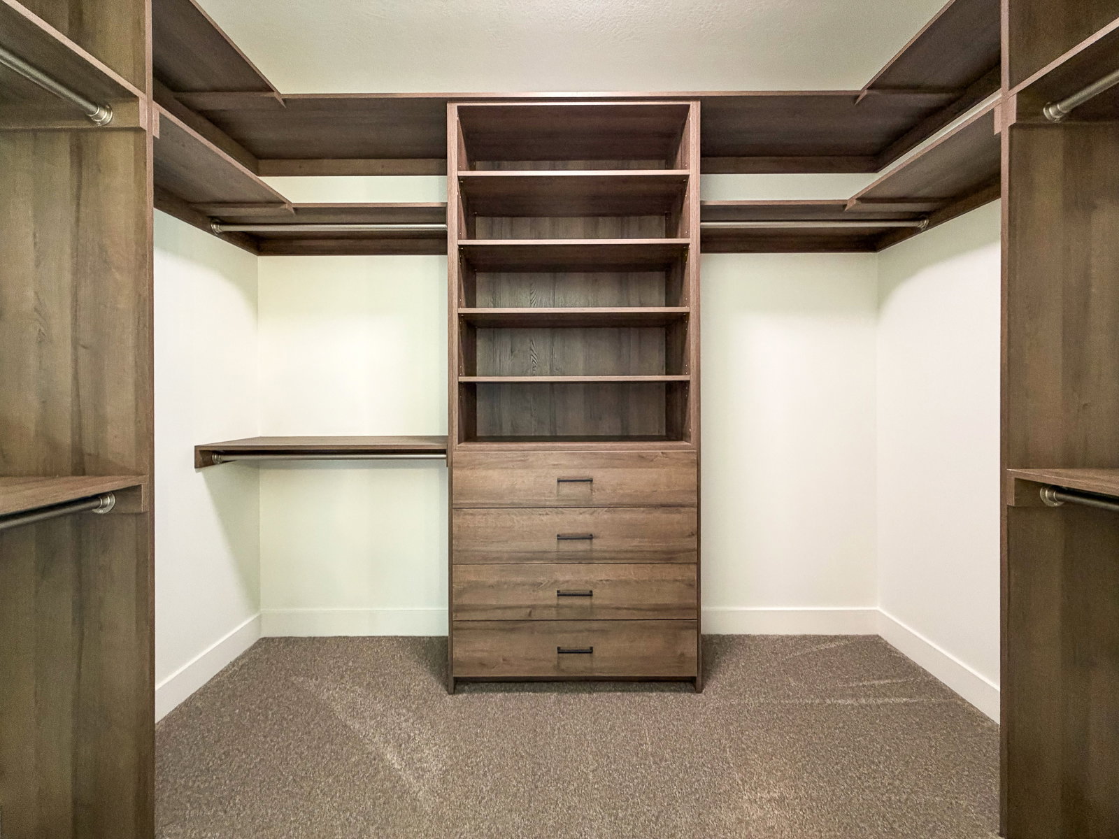Custom closet system featuring wood-finish shelving and drawers