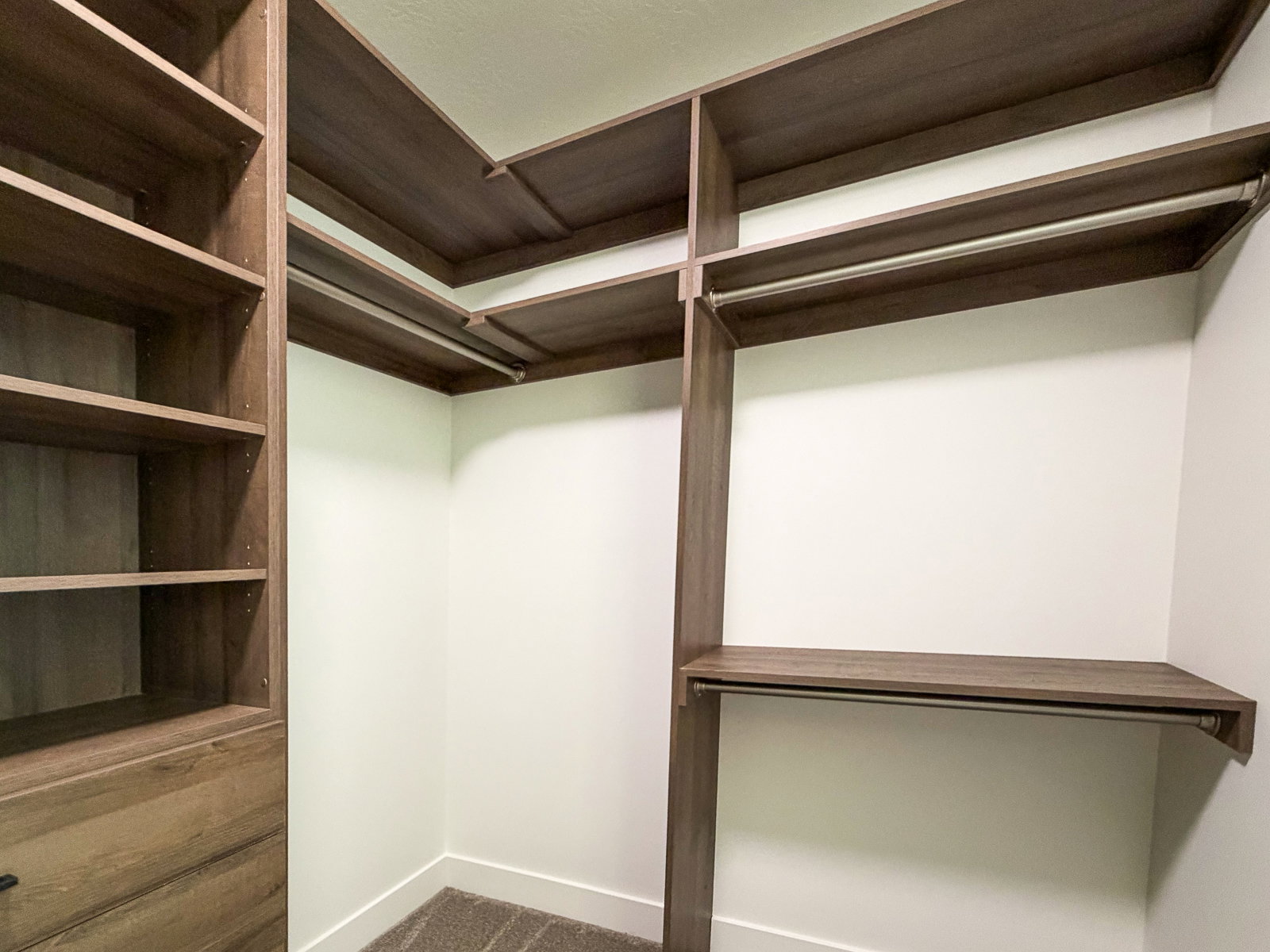 Custom closet system featuring wood-finish shelving and hanging rods