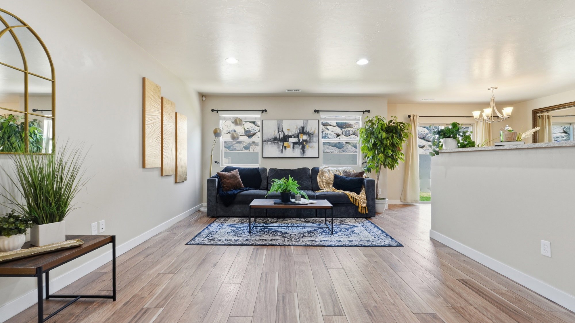 Open concept living area featuring wood-finish flooring, light-toned walls, and recessed lighting