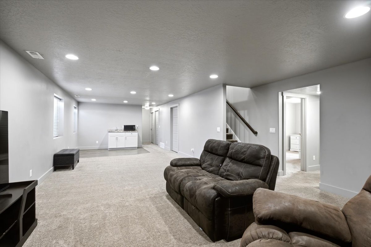 Expansive lower-level space featuring recessed lighting, light-toned carpeting, and neutral wall finishes