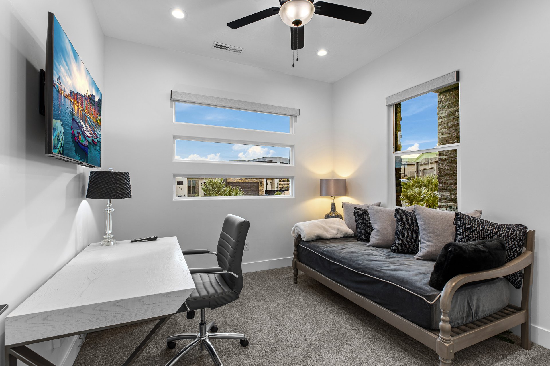 Room featuring multiple windows, recessed lighting, and a ceiling fan