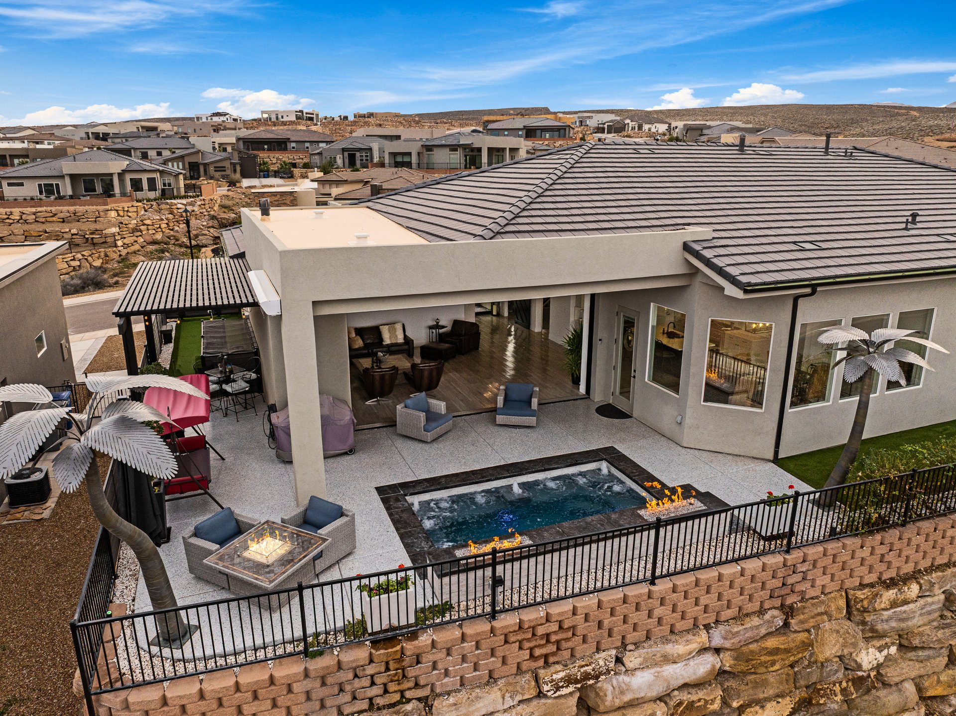 Outdoor patio with a built-in hot tub, fire pit, and expansive covered area