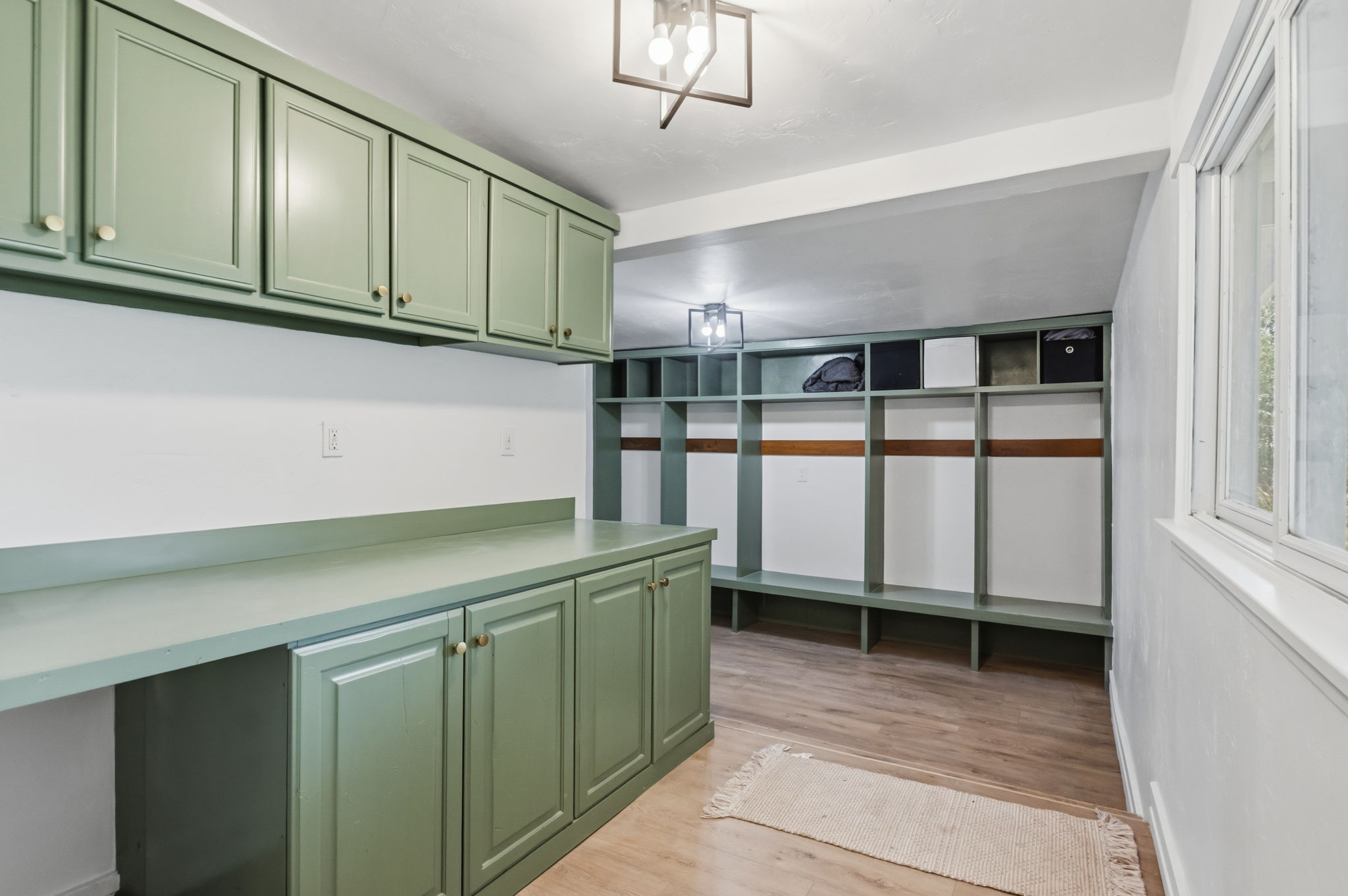 Mudroom featuring built-in cabinetry, extensive counter space, and integrated cubby storage