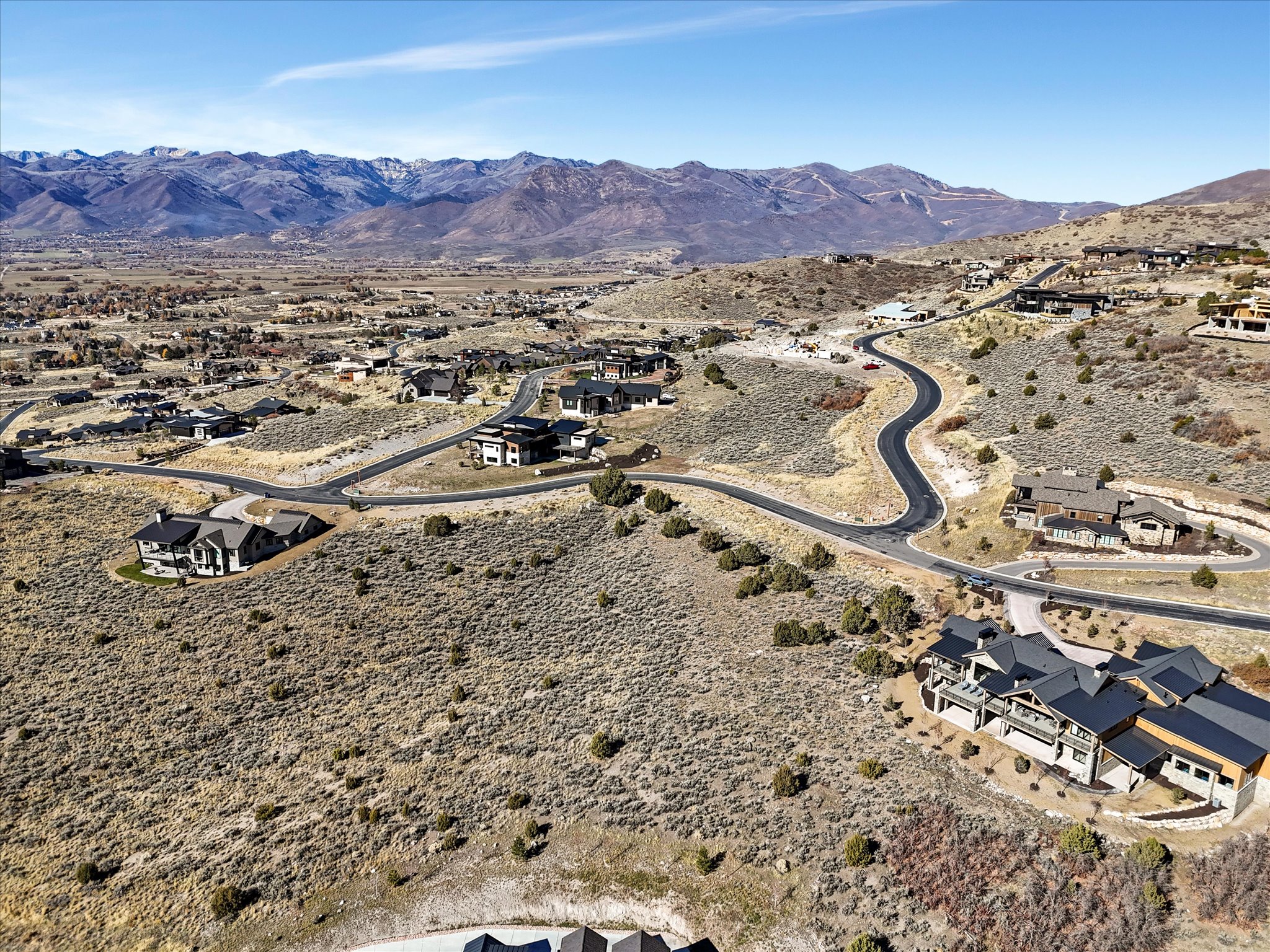 Expansive hillside development featuring multiple contemporary and traditional homes with varied rooflines